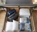 small double ottoman bed storage capacity with suitcases and bedding inside, UK