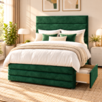Green velvet upholstered bed frame with tall panelled headboard and gold metal legs in a modern bedroom